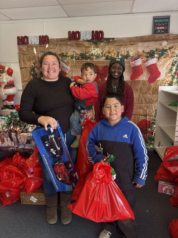 Family celebrating Christmas with gifts and decorations.