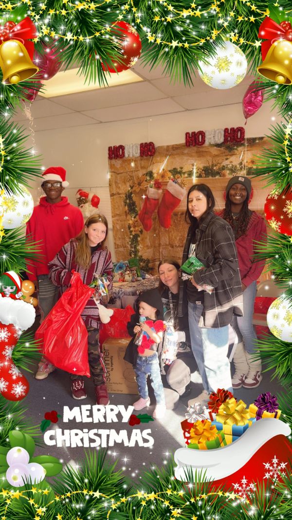 Group of people celebrating Christmas with gifts and decorations.