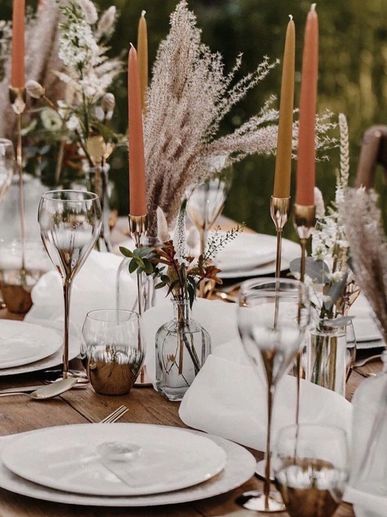 Beautiful boho table styling includes bud vases, dried flowers, champagne coloured floral patterned 