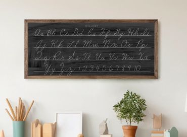 Chalkboard displaying cursive alphabet and numbers in a cozy room.