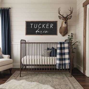 Rustic nursery with a metal crib and deer head mount.