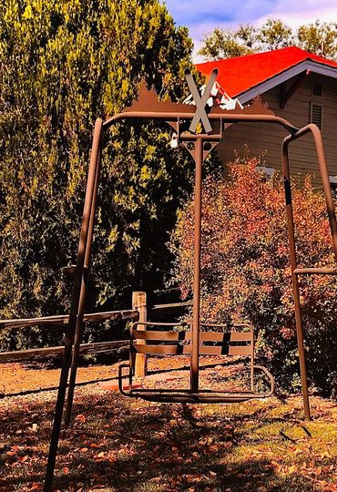 Swing built for two using old ski lift and metal pipe.