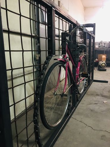 custom made gate using repurposed material including retro bicycle