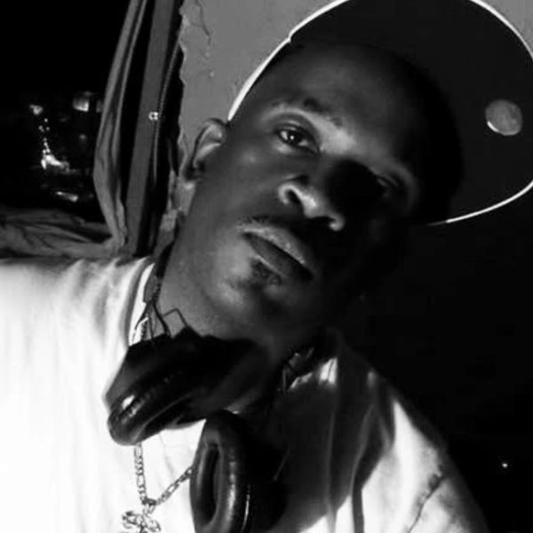 Man wearing a cap and headphones in black and white photo.