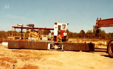 A construction vehicle with two workers on a sunny day.