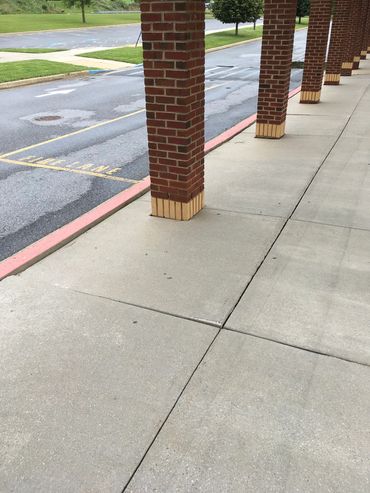 Example of a sunken public concrete sidewalk adjacent to its curb