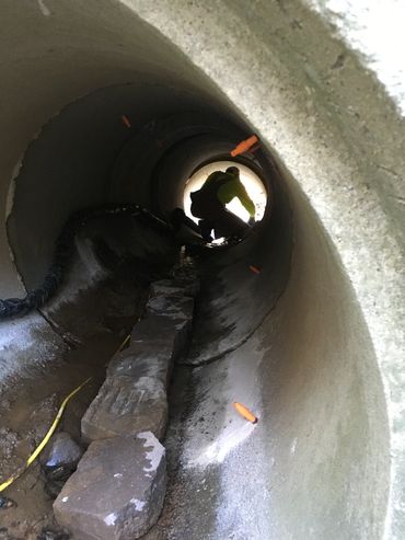 Concrete raising in action inside a tunnel under driveway in culvert