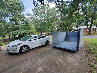 20 yard dumpster rental in Duluth, GA with rear door open.