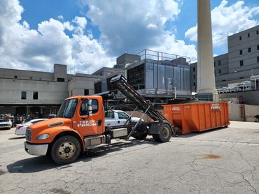 Roll off truck delivering a 30 yard dumpster