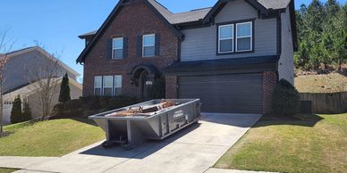 10 yard dumpster in driveway loaded ready for pickup
