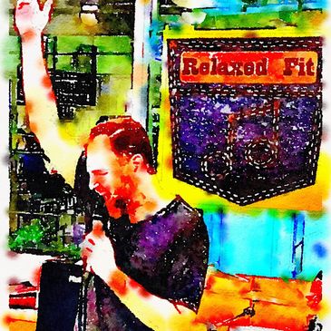 Man singing with one arm raised and microphone in hand.