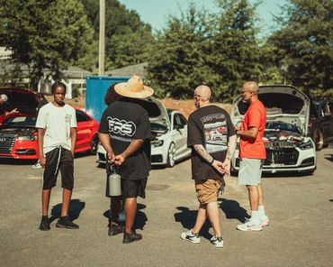 Members of the Audi club chatting outside Wolfpen Euro auto repair in Roswell Georgia