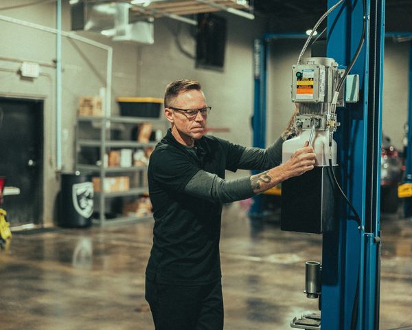 Automotive technician working Rotary lift at Wolfpen Euro Auto Repair in Roswell, GA north Atlanta