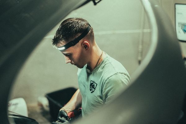 Factory trained Mercedes technician working on Porsche Macan at Wolfpen Euro Auto Repair in Roswell