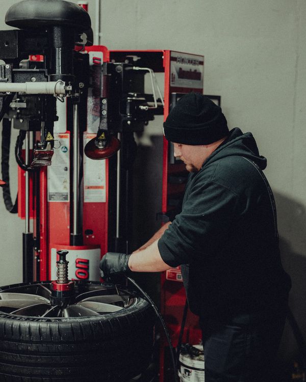 Auto tech performing tire change on Hunter tire system at Wolfpen Euro Auto Repair in Roswell