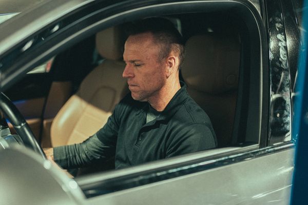 Auto tech checking Porsche Macan instrument panel at Wolfpen Euro Auto Repair in Roswell, GA