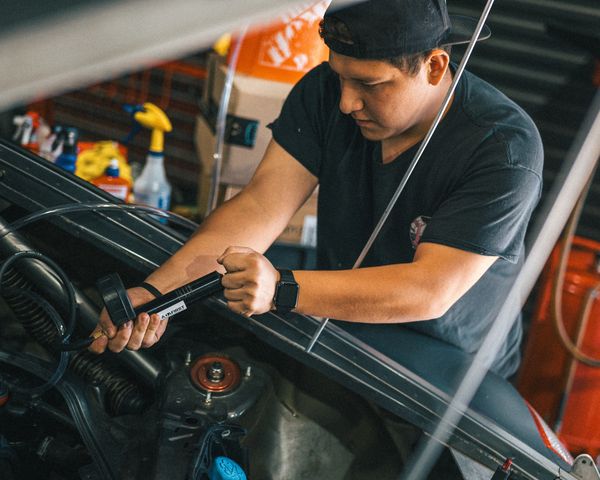 Factory trained Porsche technician performing coolant system check at Wolfpen Euro Auto Repair