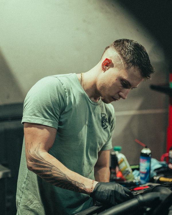 Factory trained Mercedes technician working on Porsche Macan at Wolfpen Euro Auto Repair in Roswell