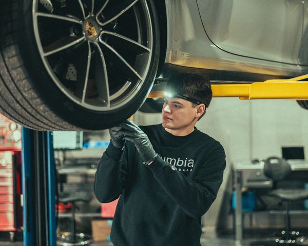 Factory trained Porsche technician inspecting Porsche 911 tires at Wolfpen Euro Auto Repair Roswell