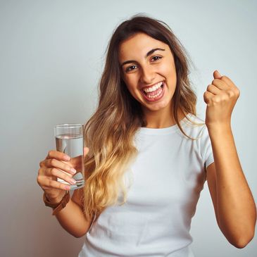 happy lady drinking a glass of hydrogen water