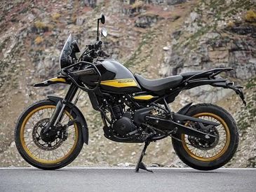 Black and yellow adventure motorcycle parked on a mountain road.