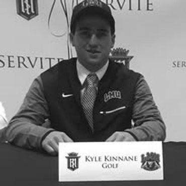Kyle Kinnane at a golf signing event wearing a Nike jacket and cap.