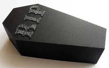 Black coffin-shaped box with glittery 'RIP' letters on top.