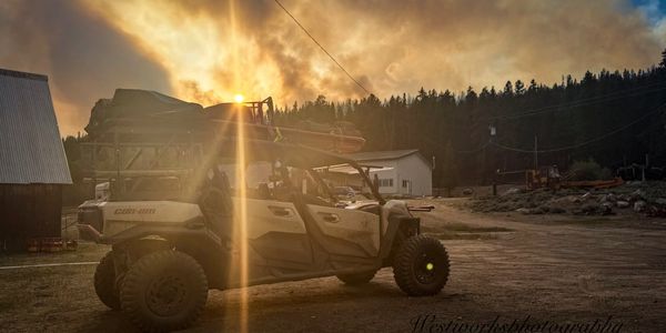 Off-road vehicle at sunset with sun rays.