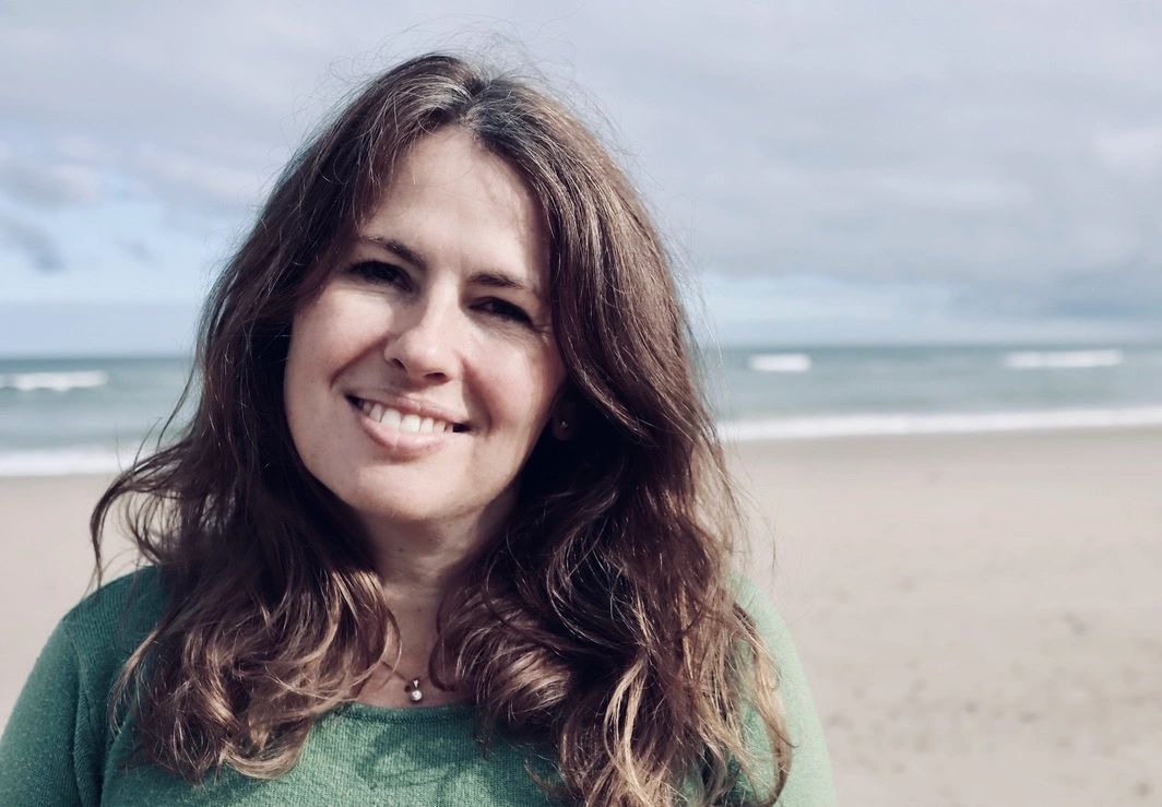 Rosanne smiling on the beach