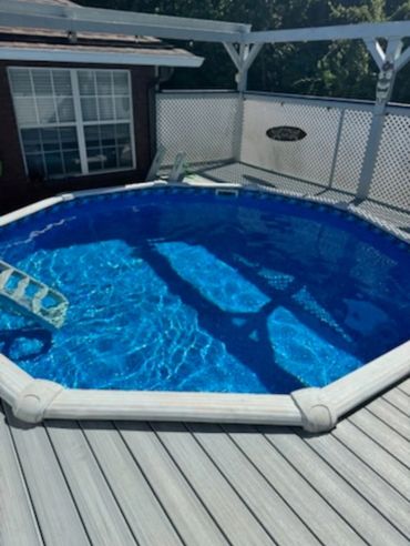 Above-ground pool with newly installed blue liner filled with clear water