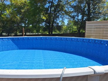 Above-ground pool with new liner installed after liner replacement in Pensacola, FL