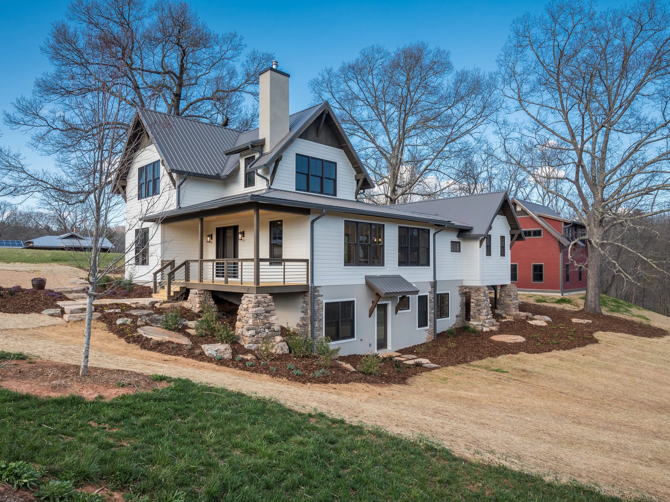 Painter preparing to paint a white wall with rollers and a ladder.