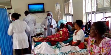 Dr. Sr. Busingye rounding with OBGYN residents during a birth injury camp.