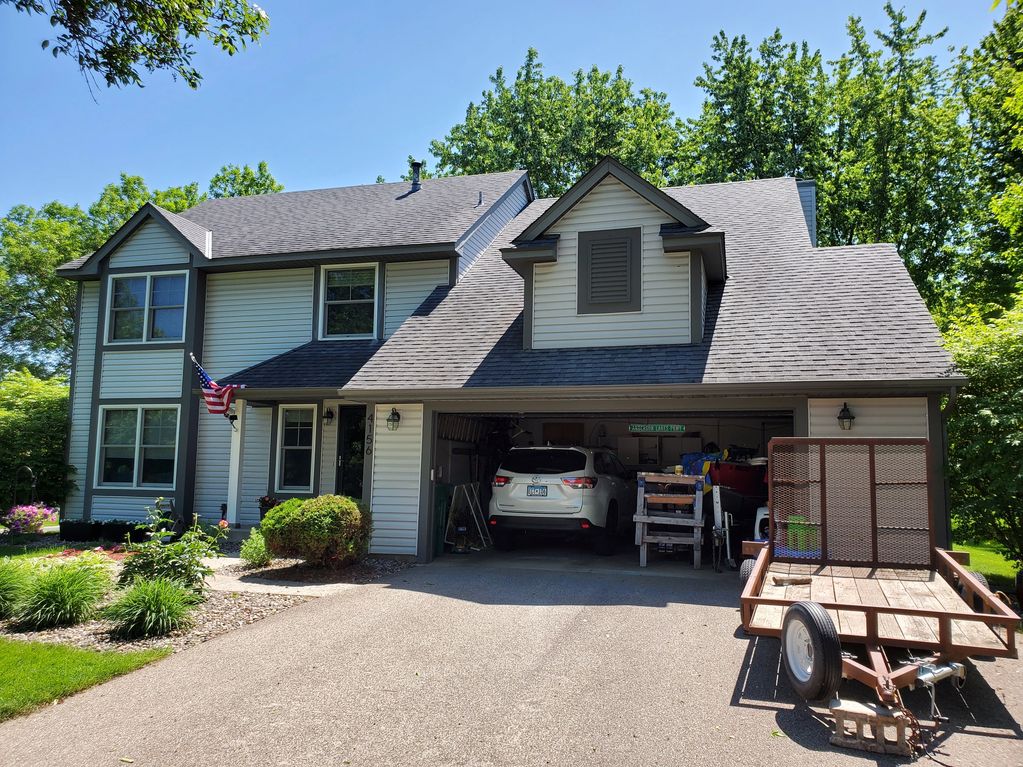 BEFORE the Roofing, LP Smartside siding, soffit and fascia, gutters, and garage door remodel