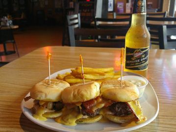 Bacon cheese sliders  and French Fries on a plate with a dipping sauce