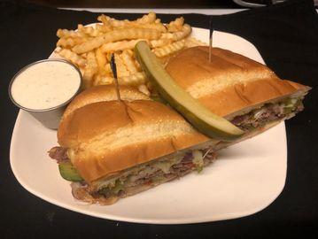Philly Steak Sandwich with fries on a plate
