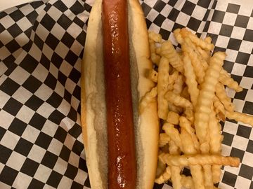 foot long hot dog with fries in a basket