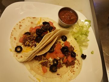 2 Street tacos on a plate with salsa