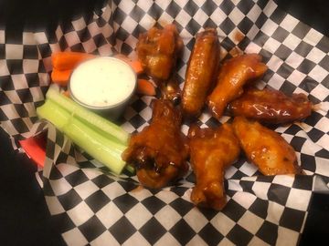 Wings with carrots celery and ranch in a basket
