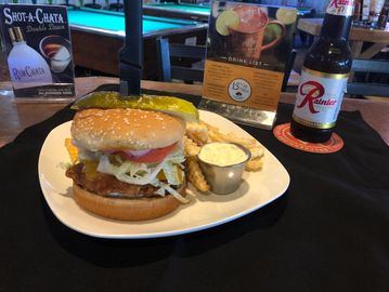 fish Sandwich Burger fries and a Rainier beer on a table