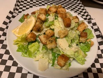 A side Caeser salad in a bowl