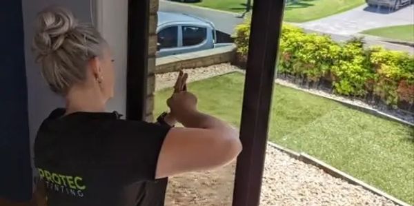 Protec Tinting expert applying high-quality window film for heat reduction, privacy & UV protection