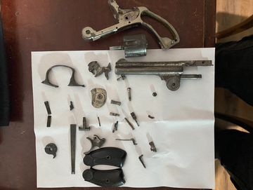 Revolver with parts removed and being repaired by our competent gunsmith.