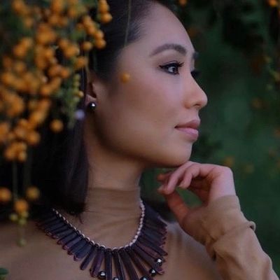 Profile of a woman with a stylish necklace.