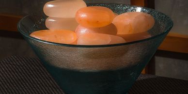 Himalayan Stone massage using warm salt stones for detoxification, stress relief, and relaxation.
