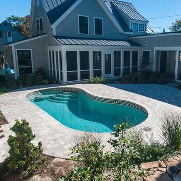 Backyard with a swimming pool and modern house.
