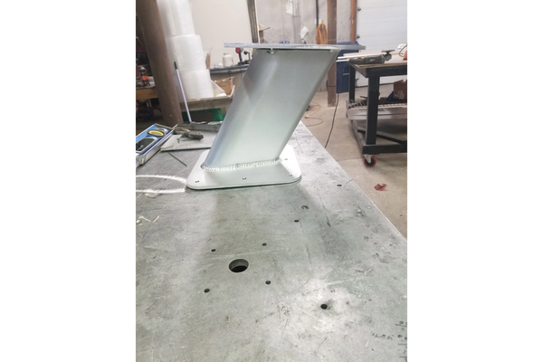 The vessel has a white superstructure above a dark blue hull,which transitions to a red anti-fouling