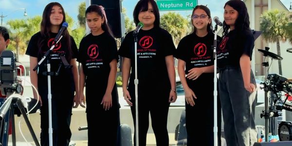 Five School of Talent students on stage at Kissimmee's Hop On Downtown event.