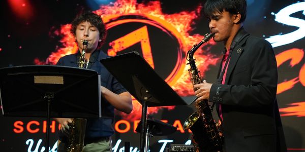 Student and teacher play the Saxophone at 2026 Spring Concert.