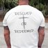 Man wearing a white shirt with 'Rescued or Redeemed' and a cross design on the back.